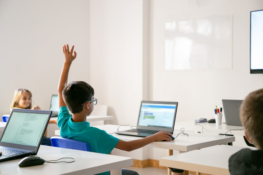 students using computer in classroom