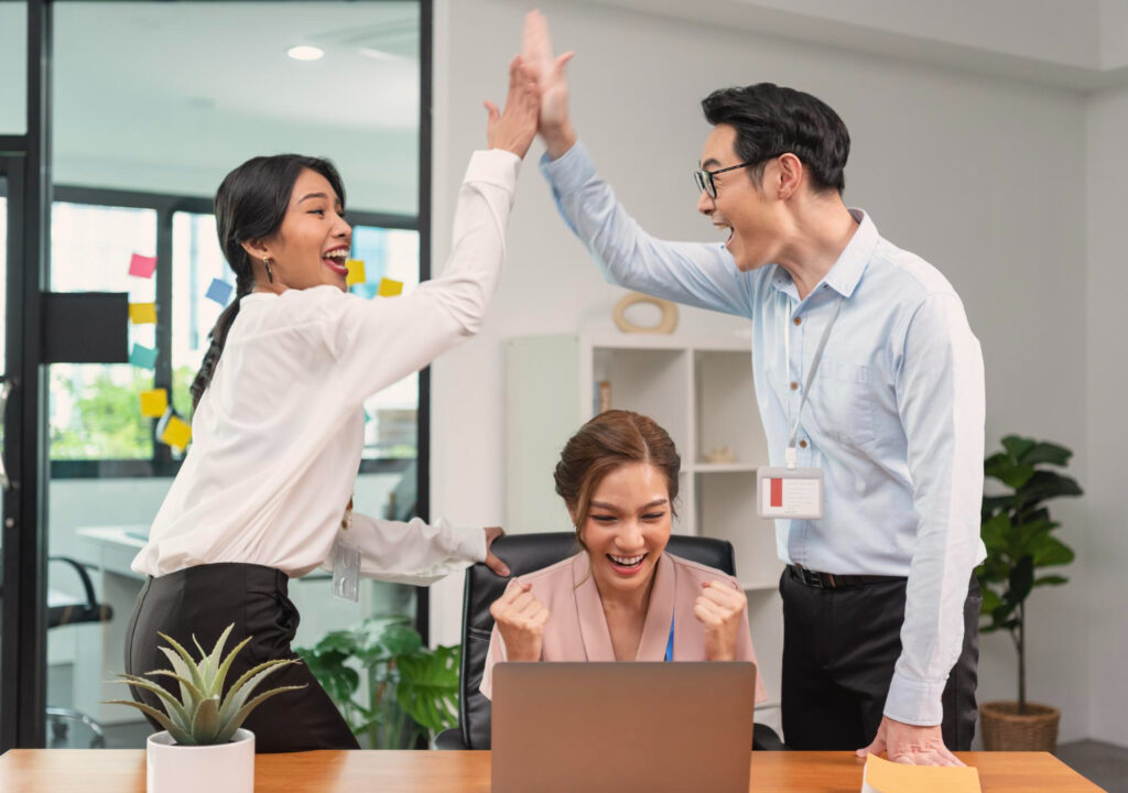 happy asian teachers in office